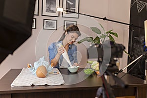 Vlogger filming video about preparation of baby porridges
