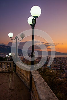VLORA, ALBANIA: Cityscape seen from Kuzum Baba hill. Aerial city view, city panorama of Vlore at sunset.