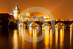 Vltava River and Charles Bridge with Old Town Bridge Tower by night, Prague, Czechia. UNESCO World Heritage Site
