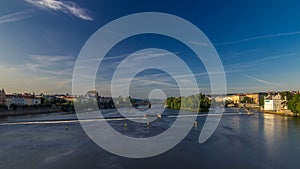 Vltava river timelapse hyperlapse in district Strelecky ostrov with the bridge of the Legions and National Theater photo