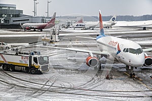 Vnukovo International aipport in Moscow. The airline company Azimuth in winter at Vnukovo airport, anti-icing aircraft