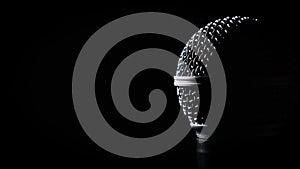 The Vocal Handheld Microphone Slowly Rotates in Backlight on Black Background