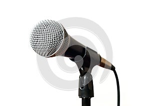 Vocal microphone with cord on a stand closeup isolated