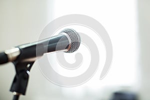 Vocal Microphone in focus against blurred audience at the conference