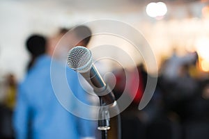 Vocal Microphone in focus against blurred audience at the conference