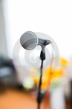 Vocal Microphone in focus against blurred audience at the conference