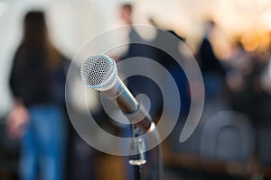 Vocal Microphone in focus against blurred audience at the conference