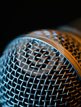 Vocal microphone macro over dark background