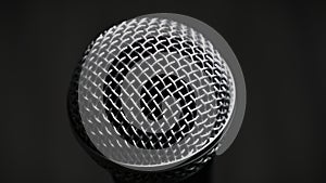 The Vocal Microphone Slowly Rotates on a Black Background Close-Up