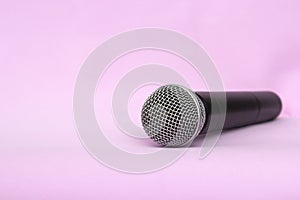 Vocal silver microphone wireless for audio recordings, karaoke on pink background