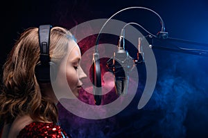 Vocal teacher singing with a studio microphone in a studio with a bright background. Teaching vocals and solo singing. Soundtrack photo