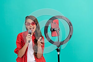 vocal tutorial lesson online. happy teenage girl singer use selfie led. kid music blogger.