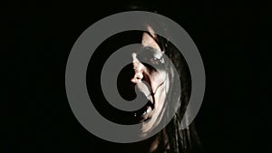 Vocalist of black metal band. Close up face at dark background