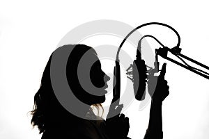 Vocals with studio microphone, silhouette. Black and white photo photo