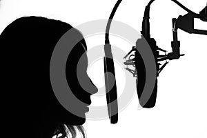 Vocals with studio microphone, silhouette. Black and white photo photo