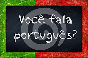Voce fala portugues blackboard with portugal flag frame photo
