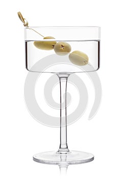 Vodka martini gin cocktail in modern glass with olives on bamboo stick on white background with reflection