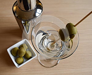 Martini with bowl of olives and drink shaker