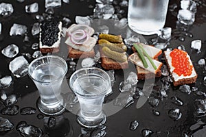 Vodka with pickled cucumber, black and red caviar