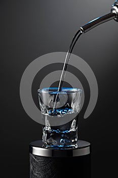 Vodka pouring from the bottle into a glass on a dark background