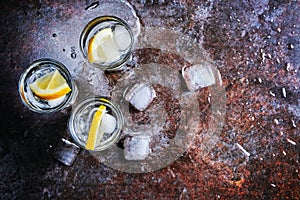 Vodka. Shots, glasses with vodka with ice .Dark stone background.Copy space .Selective focus