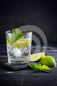 Vodka with water and ice in a glass Cup - alcoholic cocktail with lime