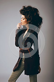 Vogue Style. Classy Fashion Model in Stylish Brown Jacket and Pants photo