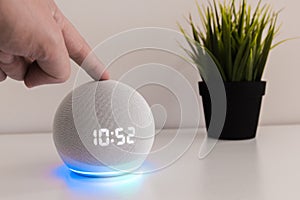 Voice controlled speaker with activated voice recognition, on light background and finger