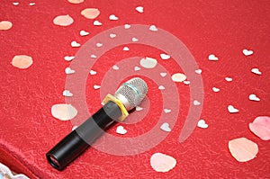 Voices of love as represented by a microphone and heart-shaped paper cuts