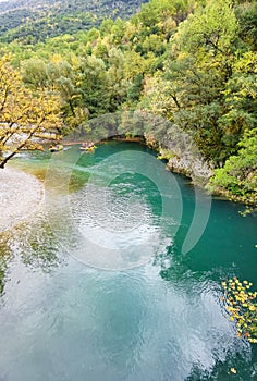 Voidomatis river in aristi village trees rafting boats in autumn season