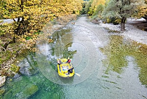 Voidomatis river in aristi village trees rafting boats in autumn season