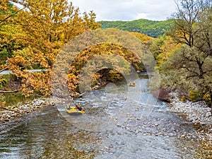 Voidomatis river in aristi village trees rafting boats in autumn season