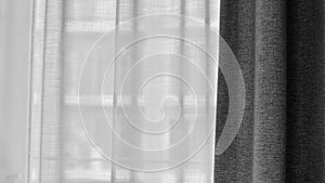 Voile curtain in front of window with grey curtain to side