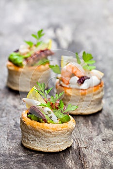 Vol-au-vents puff pastry cases filled with salted squid and oct