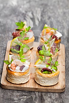 Vol-au-vents puff pastry cases filled with salted squid and oct