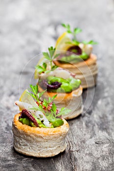 Vol-au-vents puff pastry cases filled with salted squid and oct