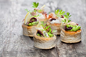 Vol-au-vents puff pastry cases filled with salted squid and oct