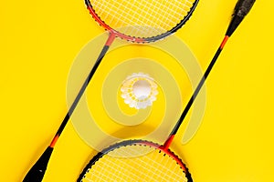 Volant and racket, badminton on yellow background. Concept excitement, resistance, competition. Pop Art Minimalism photo