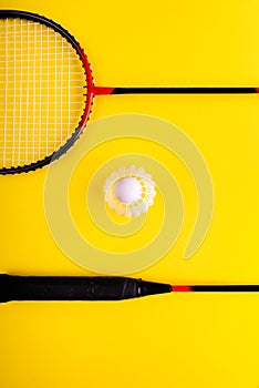 Volant and racket, badminton on yellow background. Concept of summer entertainment. Pop Art Minimalism photo