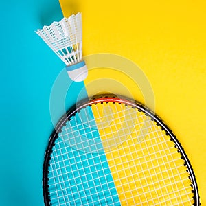 Volant and racket for playing badminton on yellow background. The concept of summer entertainment. Minimalism Pop Art