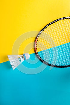 Volant and racket for playing badminton on yellow background. The concept of summer entertainment. Minimalism Pop Art