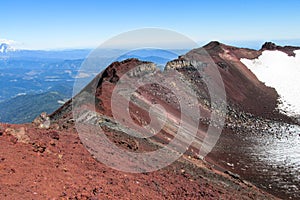 Volcan slope covered with old red lava rocks