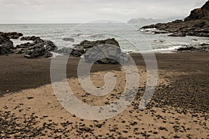 Volcanic beach in Poley Bay, Coromandel Peninsula photo