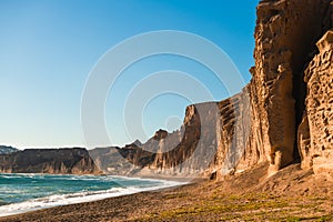 Volcanic cliffs on Vlichada beach, Santorini island, Greece. View of the sea coast at sunny day