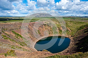 Volcanic crater Kerid with blue lake inside, at sunny day with beautiful sky, Iceland