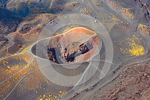 Volcanic crater on the side of the mountain, around hardened lava. Aerial view