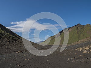 Volcanic desert landscape with green Hattafell mountain with footpatj of Laugavegur trail. Fjallabak Nature Reserve