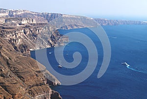 Volcanic high cliffs reaching into the ocean, Fira, Santorini, Greece