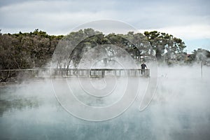 Volcanic lake with vaporizing water photo