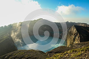 Volcanic lakes Ato Polo and Nuamuri koofai . National park Kelimutu. Kelimutu tri coloured volcano crater covered with photo